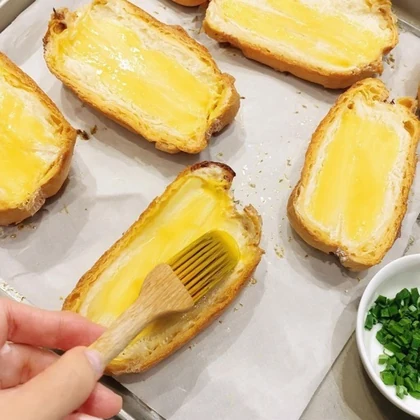 Generated image of butter being brushed onto bread slices